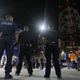 Dallas police gather as a crowd forms in downtown Dallas, early Friday, July 8, 2016. Snipers opened fire on police officers in Dallas; some of the officers were killed, police said. (AP Photo/LM Otero)